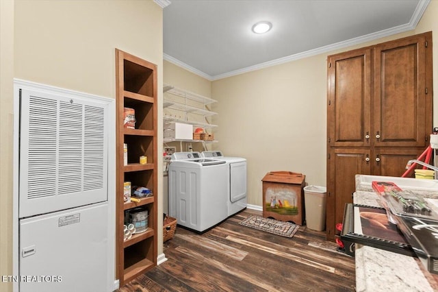 laundry room with crown molding, dark wood-type flooring, and washing machine and dryer