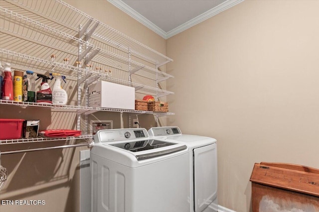 washroom featuring ornamental molding and washer and dryer