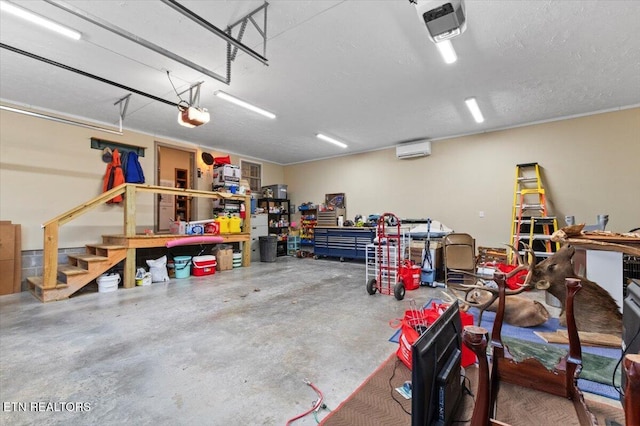 garage featuring a garage door opener, a workshop area, and an AC wall unit