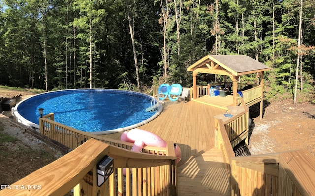 view of pool with a gazebo and a deck