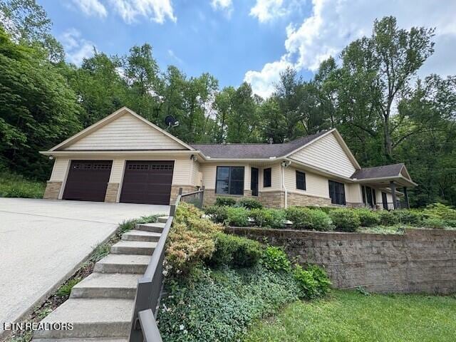 197 Evergreen Pl, Sparta, TN 38583 - ranch-style home featuring concrete driveway, a garage, and stone siding