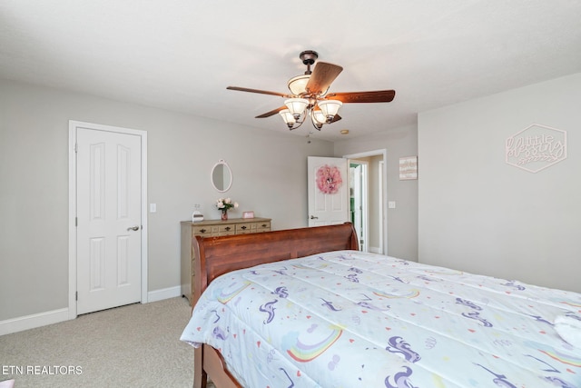 bedroom featuring light carpet, a ceiling fan, and baseboards