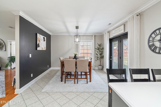 dining space featuring visible vents, baseboards, light tile patterned flooring, and crown molding