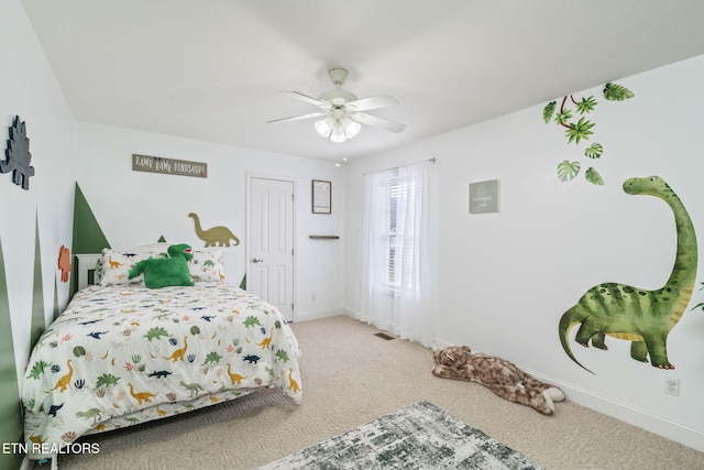 bedroom featuring baseboards, ceiling fan, and carpet flooring