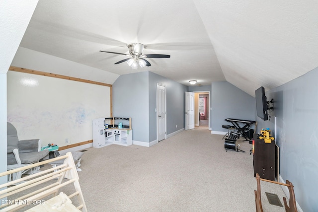 game room featuring vaulted ceiling, carpet flooring, baseboards, and ceiling fan