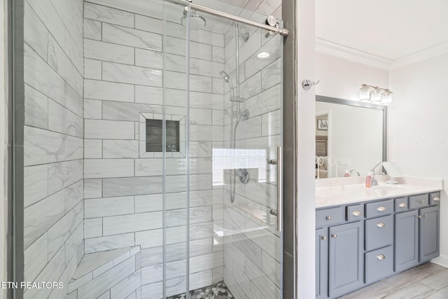 full bath featuring double vanity, a sink, a shower stall, and ornamental molding