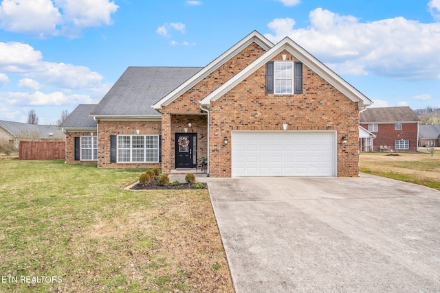 traditional home featuring fence, driveway, roof with shingles, a front lawn, and brick siding