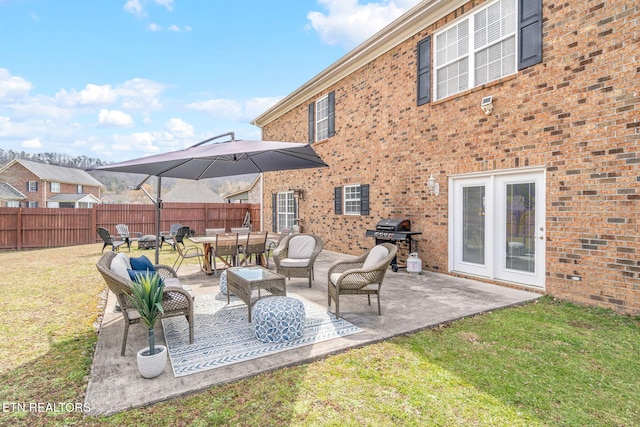 view of patio with a grill and fence