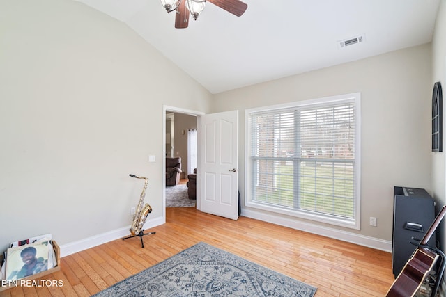 bedroom featuring vaulted ceiling, hardwood / wood-style flooring, baseboards, and visible vents