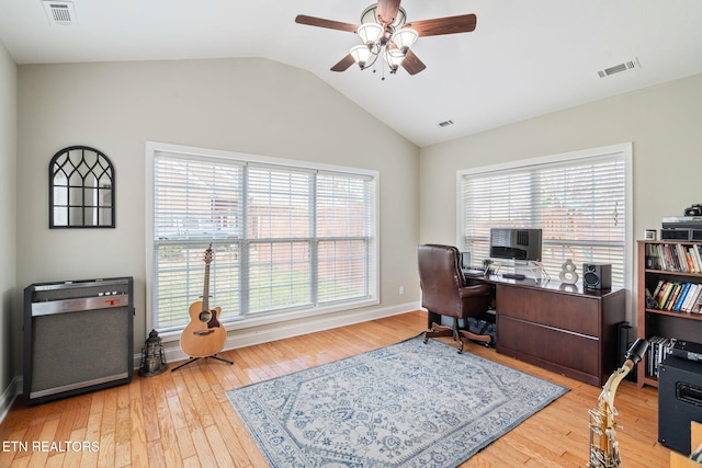 office space with visible vents, light wood-style flooring, ceiling fan, and vaulted ceiling