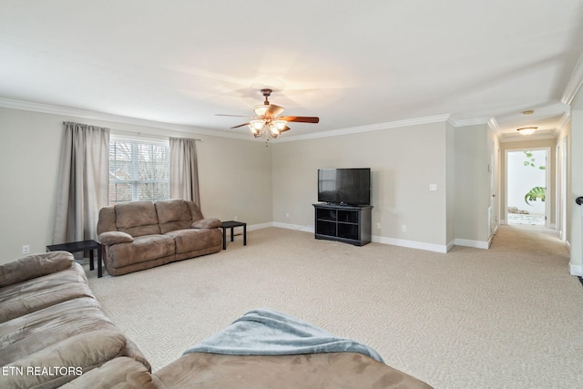 living area featuring baseboards, a ceiling fan, carpet, and ornamental molding