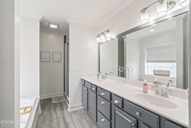 full bath with crown molding, a garden tub, double vanity, and a sink