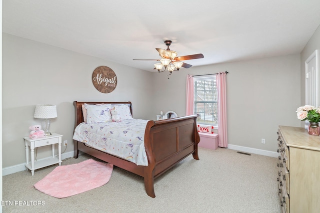 bedroom featuring light carpet, visible vents, a ceiling fan, and baseboards