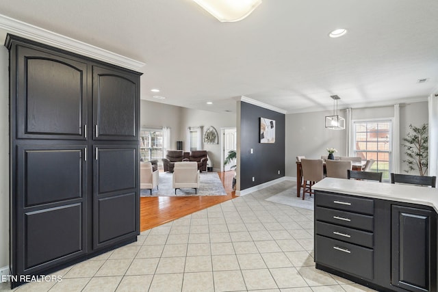 kitchen featuring light tile patterned flooring, recessed lighting, light countertops, and crown molding