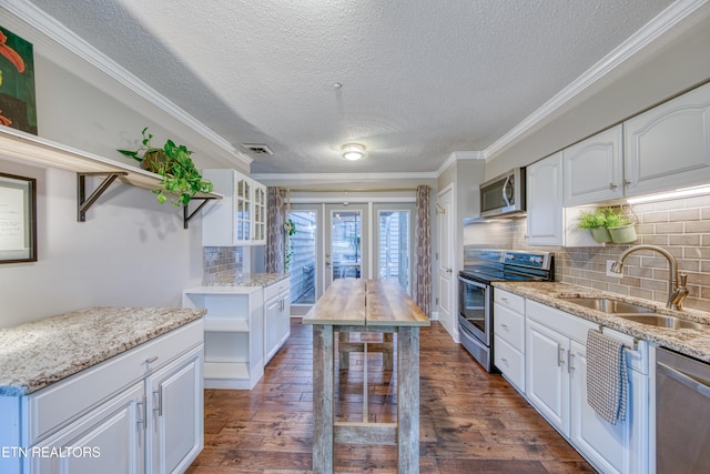 kitchen featuring white cabinetry, stainless steel appliances, sink, and light stone counters