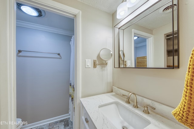 bathroom featuring vanity and a textured ceiling