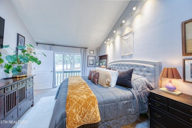 carpeted bedroom featuring lofted ceiling and access to exterior