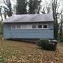 rear view of property with a garage and an outdoor structure