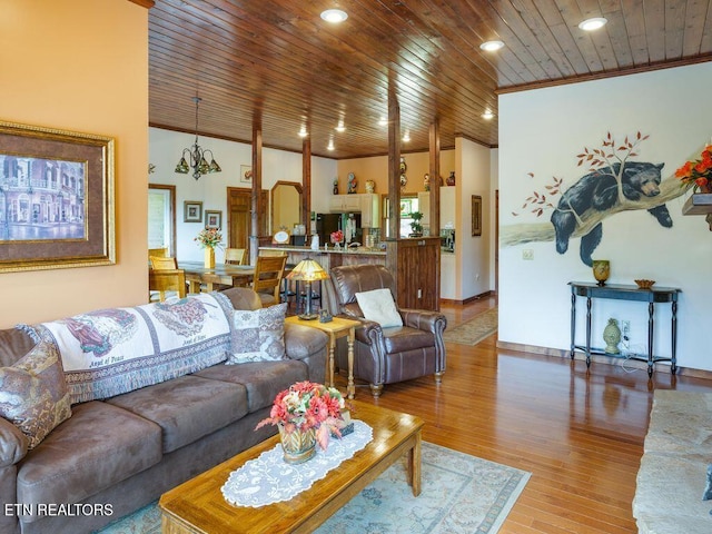 living room with crown molding, hardwood / wood-style floors, and wood ceiling