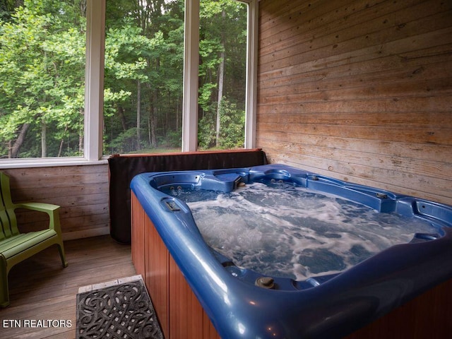 sunroom with a jacuzzi