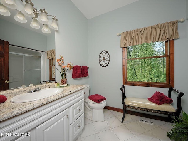 bathroom featuring tile patterned flooring, an inviting chandelier, an enclosed shower, vanity, and toilet