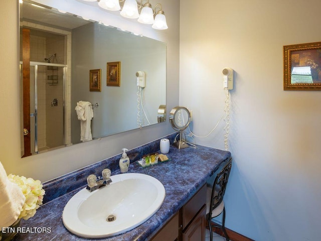 bathroom with vanity and a shower with shower door