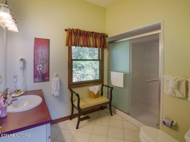 bathroom with vanity, tile patterned flooring, a shower with door, and toilet