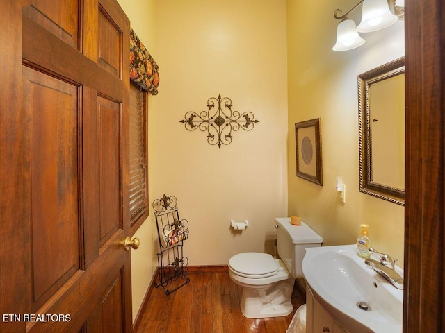 bathroom featuring vanity, toilet, and hardwood / wood-style floors