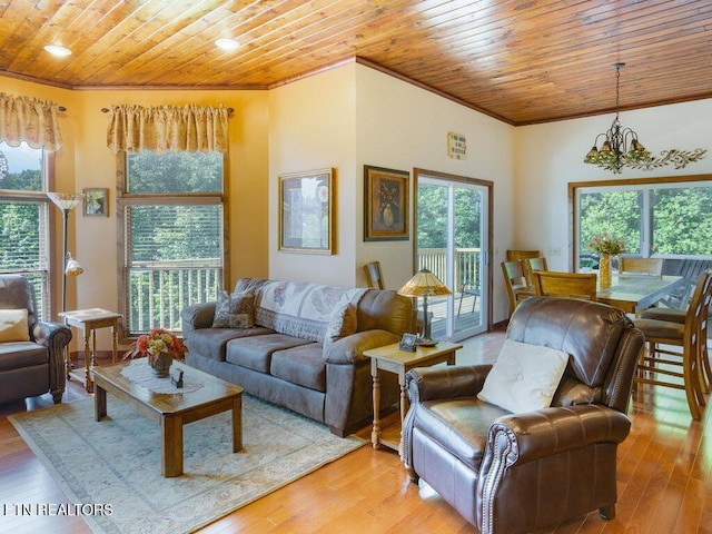 living room with ornamental molding, a chandelier, light hardwood / wood-style flooring, and wooden ceiling