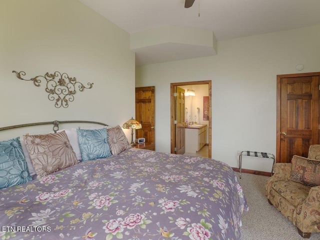 carpeted bedroom with connected bathroom and ceiling fan