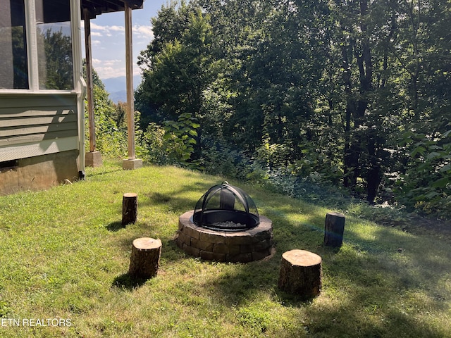 view of yard with an outdoor fire pit