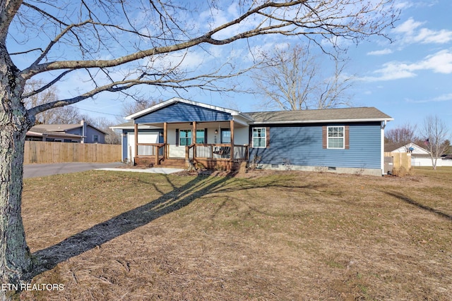 ranch-style house featuring a porch and a front yard