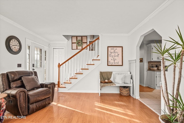 foyer featuring crown molding and light wood-type flooring