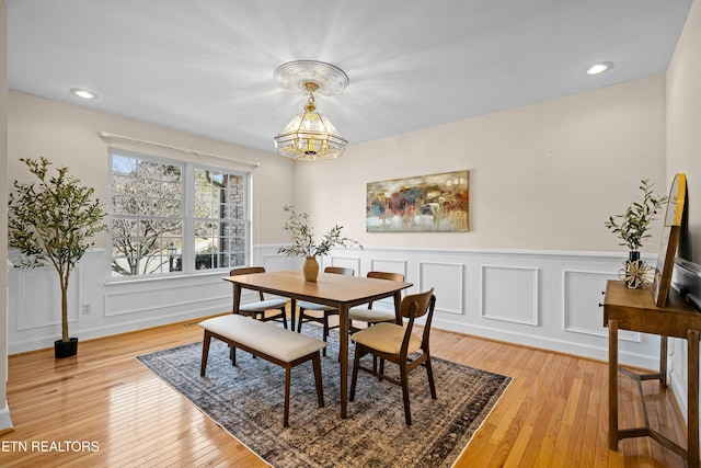 dining space with a chandelier and light wood-type flooring