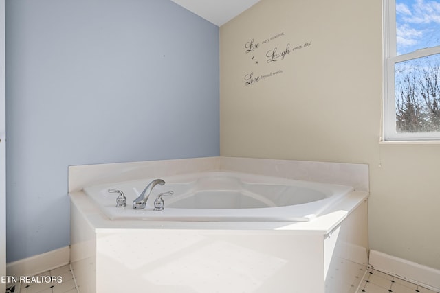 bathroom with tile patterned flooring and a bathtub