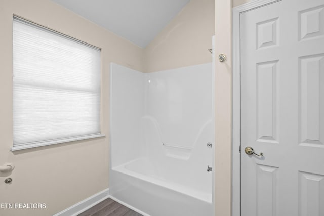 bathroom with wood-type flooring and bathtub / shower combination