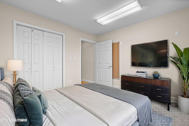 bedroom with light colored carpet and a closet