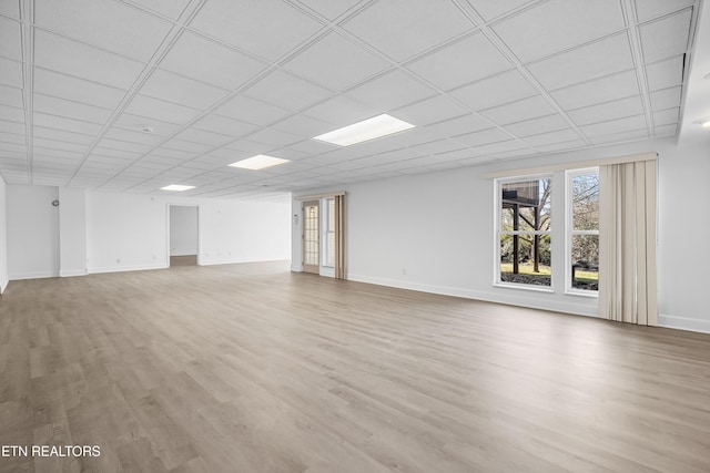 basement with wood-type flooring and a drop ceiling