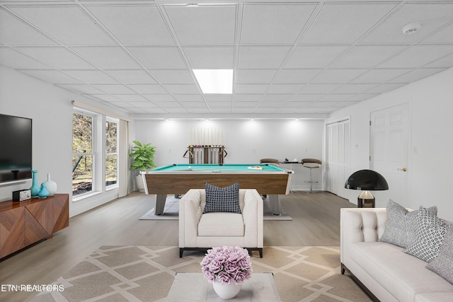 rec room featuring pool table, a paneled ceiling, and light hardwood / wood-style flooring