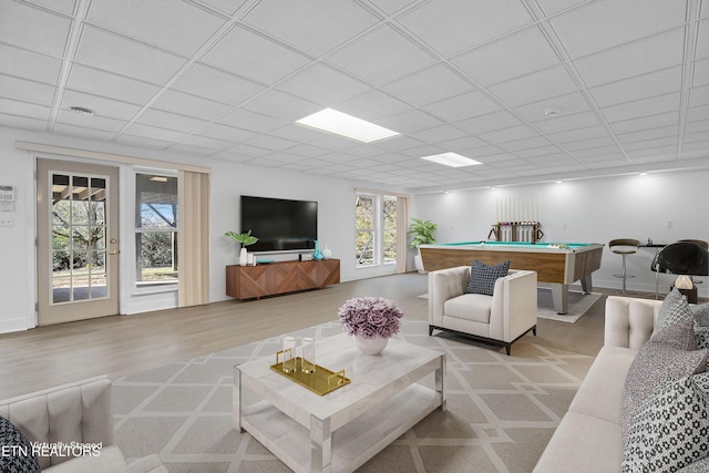 living room featuring billiards, a paneled ceiling, and light hardwood / wood-style flooring