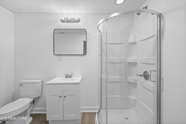 bathroom with an enclosed shower, vanity, wood-type flooring, and toilet