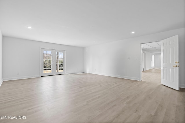 empty room featuring light hardwood / wood-style floors and french doors