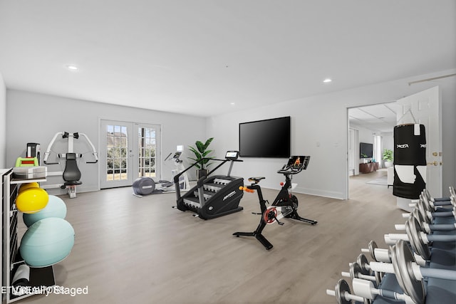 workout room with light hardwood / wood-style floors and french doors