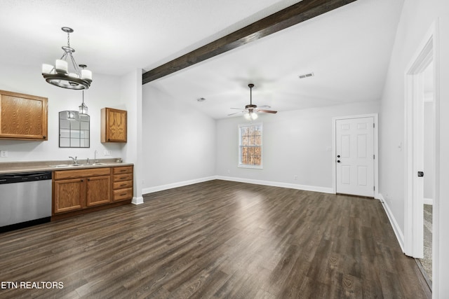 kitchen with dark hardwood / wood-style floors, pendant lighting, lofted ceiling with beams, sink, and stainless steel dishwasher