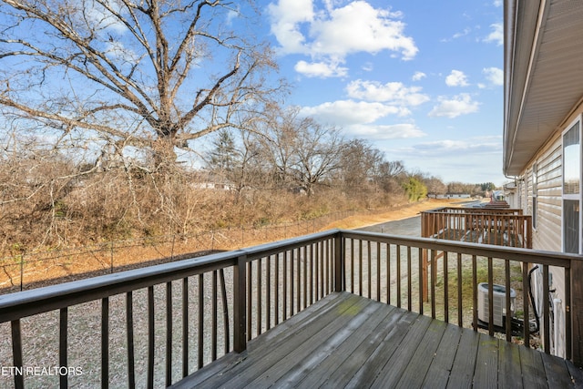 wooden deck featuring central AC unit