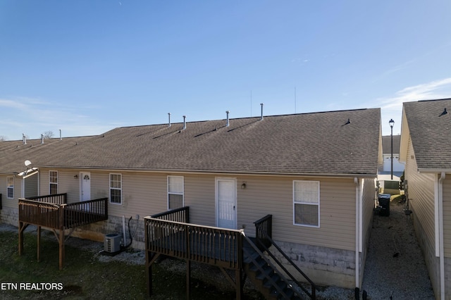 rear view of property with a wooden deck and central air condition unit