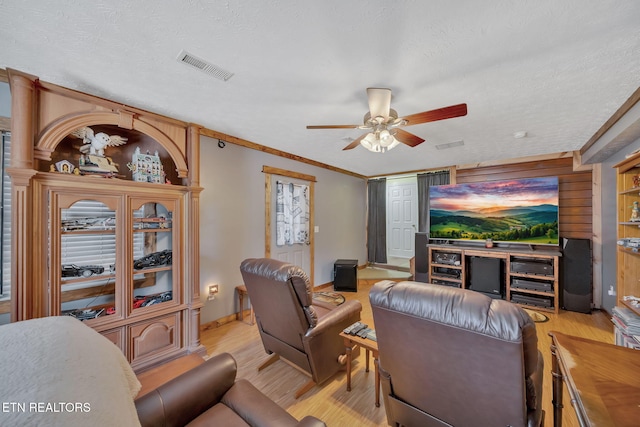 living room with a ceiling fan, light wood-style floors, and visible vents