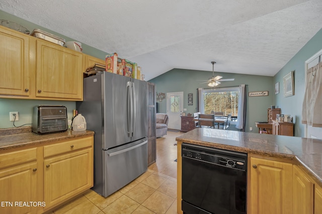 kitchen featuring ceiling fan, dishwasher, vaulted ceiling, light tile patterned floors, and freestanding refrigerator