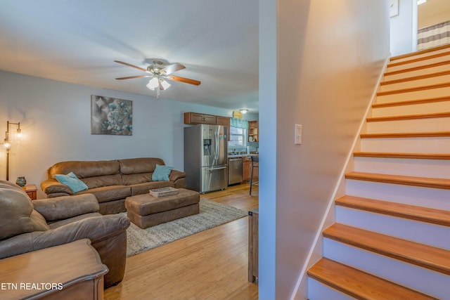 living room with ceiling fan and light wood-type flooring