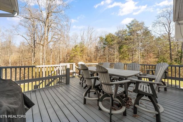 wooden deck with a grill